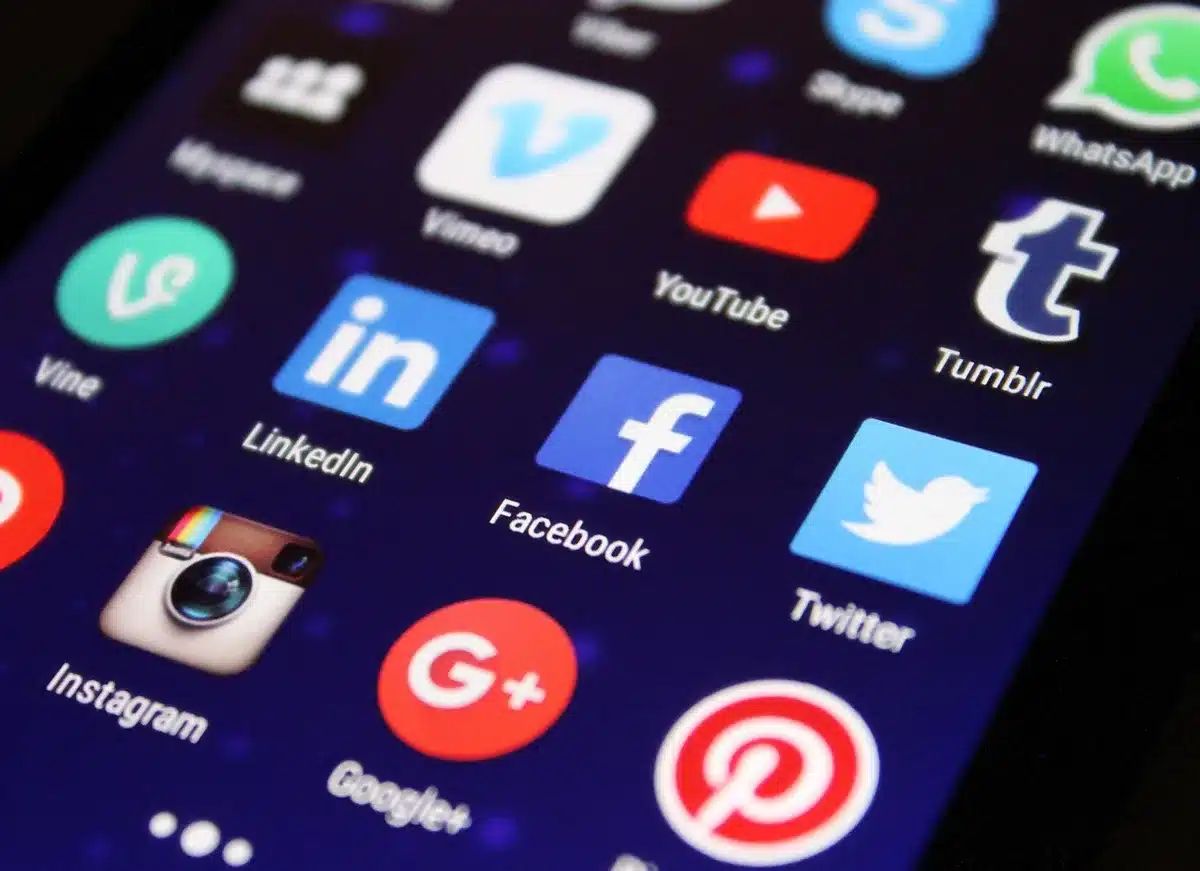 Schermo di smartphone con commenti e reazioni negative sui social media