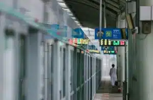 Piattaforma della metropolitana con figure anonime e atmosfera di tensione