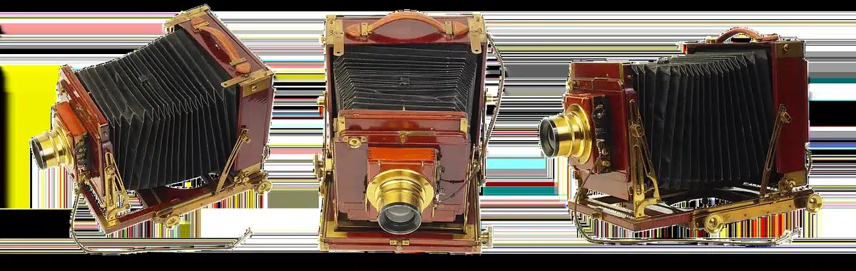 Silhouette di una cinepresa vintage su treppiede con macchina da scrivere e sceneggiature in uno studio