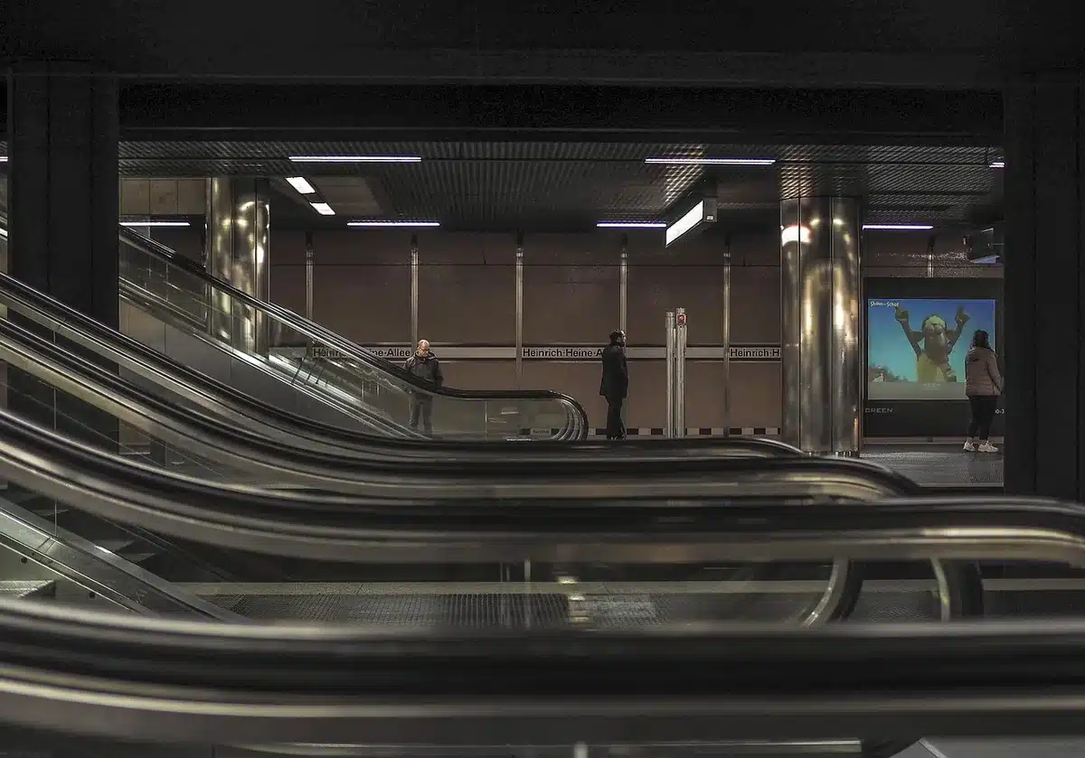 Ambiente urbano notturno con scala della metropolitana e sagoma sullo sfondo